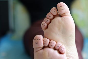 Smiley faces drawn on toes Smiley faces drawn on toes