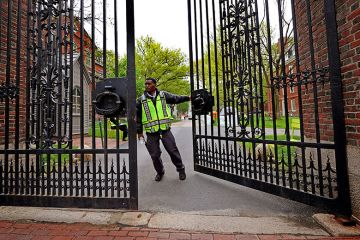 A security guard closing the Johnston Gate at Harvard University. As an illustration that Trump’s anti-DEI agenda ‘already having grave impact’, with some institutions shut down initiatives or continue them in a different guise.