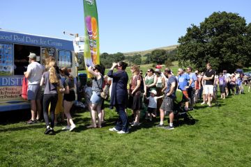 Hope, Derbyshire, UK. August 26, 2019. Families of spectators at a country show queuing for ice cream in the beautiful peak district countryside at the Hope show in Derbyshire, UK.