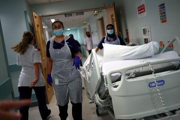 Medical staff transfer a patient through a corridor at The Royal Blackburn Teaching Hospital in East Lancashire. To illustrate that the UK’s incoming tax on international student fees could have unintended consequences for country’s health system.