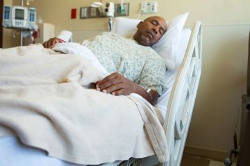 Man in hospital bed Man in hospital bed