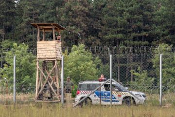 September 10, 2016: Hungarian policemen watching the Serbia Hungarian border fence September 10, 2016: Hungarian policemen watching the Serbia Hungarian border fence