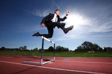 Businessman jumping a hurdle Businessman jumping a hurdle