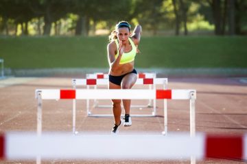 A woman jumping hurdles, illustrating meeting learning outcomes A woman jumping hurdles, illustrating meeting learning outcomes