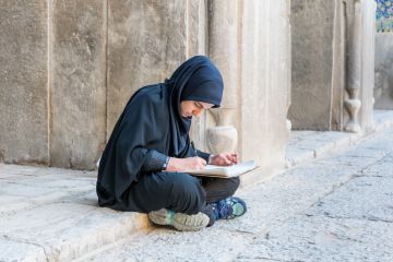 An Iranian student sits on the ground, illustrating inequliaty in university entrance An Iranian student sits on the ground, illustrating inequliaty in university entrance