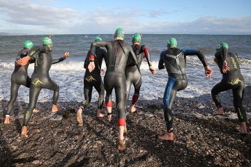 Athletes start the swim section of an ironman competition, Edinburgh, Scotland. To illustrate universities preparing for a ‘highly competitive’ clearing round.