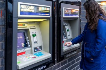 Young Adult Woman withdrew cash from ATM machine