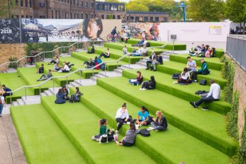 Young People students sitting outdoor on Granary Square steps.