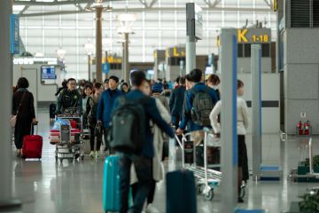 People with suitcases and luggage carts at Incheon International Airport