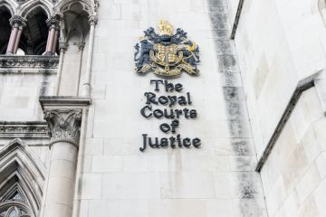 rest on the wall of Royal Courts of Justice on the Strand in central London