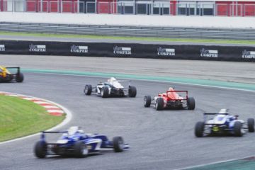 Blurred motion of Formula cars driving on track
