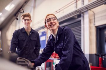 Students looking at car engine on auto mechanic apprenticeship course