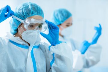 Doctors wear protective suits