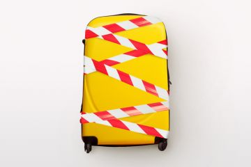 A yellow suitcase bound up with tape A yellow suitcase bound up with tape