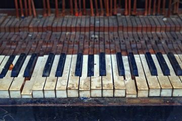 The keyboard of an old vintage piano in ruined condition