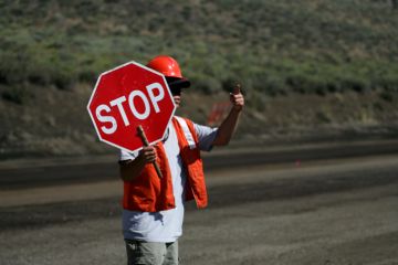 A man holds a 'stop' sign A man holds a 'stop' sign