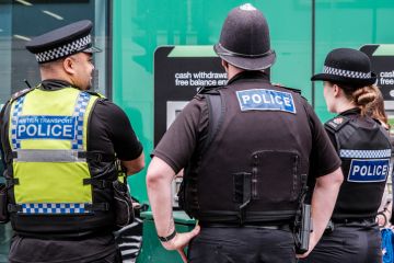 Three Police Officers Standing Patrolling For Public Safety