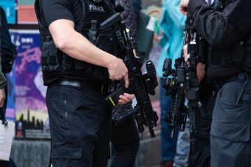 Horizontal shot of armed police patrolling Horizontal shot of armed police patrolling