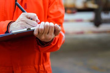 Close-up of some hands holding a clipboard and writing something Close-up of some hands holding a clipboard and writing something