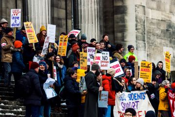 A group of students on the steps of their university in Leeds, England