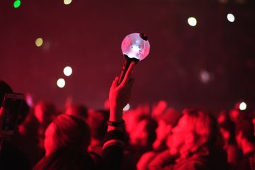 Kpop fan raises light stick lamp at a Kpop concert