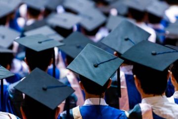 University graduates in graduation gowns and caps