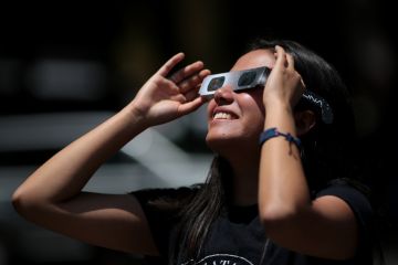 Girl watches solar eclipse