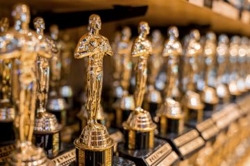 Hollywood Golden Oscar Academy Trophies Arranged On Shelf For Sale In Shop.
