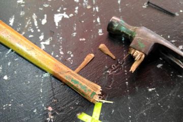 Close-Up Of Broken Hammer Handle On Table