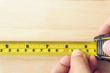 Hand Holding A Tape Measure