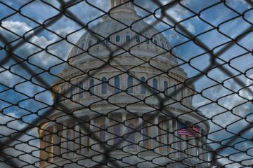 The US Capitol building in Washington behind barbed wire