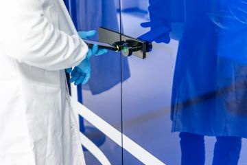 Scientist using phone to open laboratory door