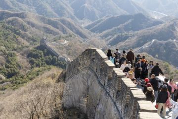 The Great Wall in Badaling with lots of visitors on a sunny day in autumn.