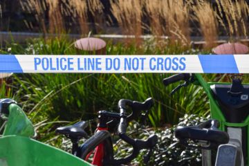 detail of police 'Do Not Cross' tape at a scene of an accident.