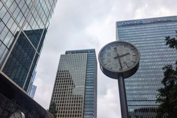 A public clock stands at Reuters Plaza before the modern glass skyscrapers, including the JP Morgan Chase building, in the Canary Wharf financial district A public clock stands at Reuters Plaza before the modern glass skyscrapers, including the JP Morgan Chase building, in the Canary Wharf financial district