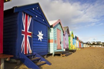 Closed beach huts with Australian flag