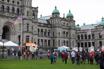 Participants in an Idle No More rally march towards the British Columbia Legislative Building