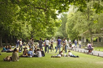 Groups of visiting students (tourists) relaxing in St Stephen\'s Green