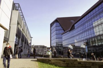 Students can be seen walking to and from the Roland Levinsky building at the University Of Plymouth in the city centre of Plymouth.