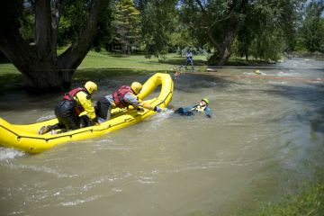 A rescue team readies to pull a mock victim to safety during a Swift Water Rescue training exercise.