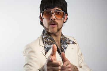 Trying too hard? Academics need to strike the right tone with their academic profiles if they want to attract PhD students. A man pulls a cheesy pose in 1970s clothing. Academics need to strike the right tone with their academic profiles if they want to attract PhD students.