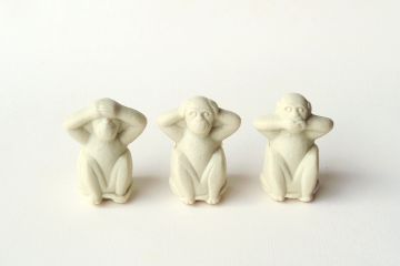Three monkey statuettes in 'see no evil, hear no evil, speak no evil' poses Three monkey statuettes in 'see no evil, hear no evil, speak no evil' poses