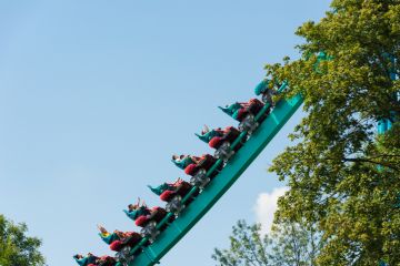 Visitors enjoying a roller coaster ride as it ascends