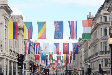 A number of different national flags are displayed above a London street A number of different national flags are displayed above a London street