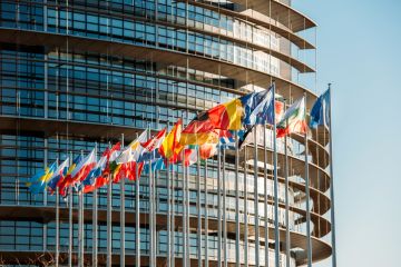 The European Parliament building in Strasbourg, France with flags waving on a spring evening The European Parliament building in Strasbourg, France with flags waving on a spring evening