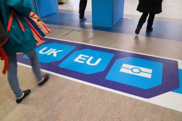 December 2, 2016: Passport control signage on the floor at Gatwick Airport directs passengers to 'non EU', 'UK' and 'EU' passport control points. 