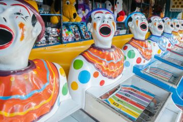 A row of sideshow carnival game clowns with mouths open