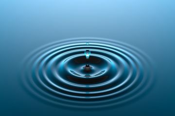 raindrop hitting water to create ripple as a way to show impact in research