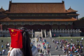 Young Chinese girl with a Chinese Flag in her head at the Forbidden City in the city of Beijing. Young Chinese girl with a Chinese Flag in her head at the Forbidden City in the city of Beijing.