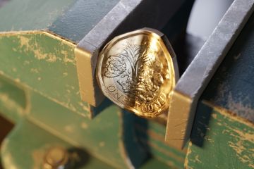 British pound coin squeezed by a bench vice British pound coin squeezed by a bench vice